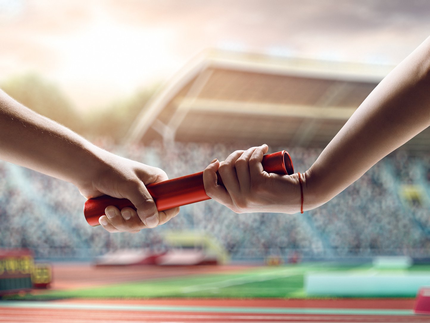 Close up of exchanging relay baton on a race